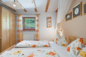 a bedroom with a bed and a window at Grafaierhof in Kastelruth