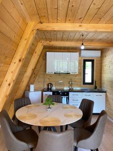 a kitchen and dining room with a table and chairs at Monark Villas in Theth