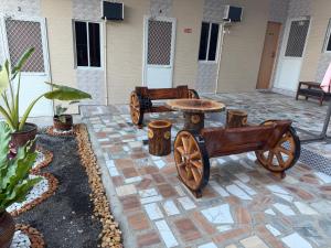 a patio with a table and a wooden cart at Amad's Rental Space Family Room in Bantayan Island +3 photos