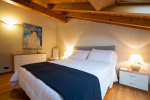 a bedroom with a large bed with a blue blanket at Albergo Giardino in Cernobbio