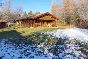 a log cabin with snow on the ground in front at Ferienhaus Tauber 21 in Hayingen