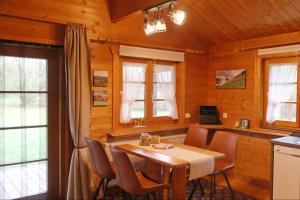 a wooden dining room with a table and chairs at Ferienhaus Tauber 21 in Hayingen