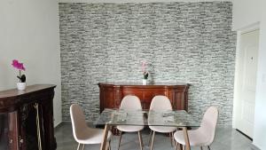 a dining room with a glass table and white chairs at Comfortable apartment with pool, close to the beach in Acapulco