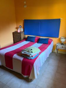 a bedroom with a large bed with a blue headboard at cabañas los juanes in Tres Arroyos