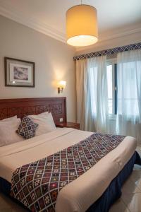 a bedroom with a large bed and a window at Swiss Wellness Boutique Hotel Hurghada in Hurghada