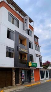 a building with a sign on the front of it at Atong Hotel in Chancay