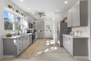 a kitchen with white cabinets and stainless steel appliances at Blue Betty Acre in Overgaard