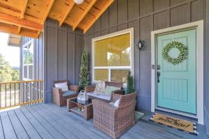 a porch with wicker chairs and a door with a wreath at Blue Betty Acre in Overgaard +25 photos