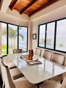 a dining room with a large white table and chairs at Oceanfront House With Pool and BBQ in San Clemente