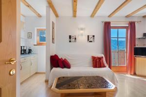 a bedroom with a bed with red pillows at Grafaierhof in Kastelruth
