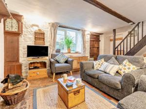 a living room with a couch and a tv at 3 Bed in Ventnor oc-93525 in Niton