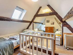 a attic bedroom with two beds and a crib at 3 Bed in Ventnor oc-93525 in Niton