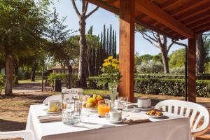 a white table with food and drinks on it at Borgo San Giorgio by La Principina in Grosseto