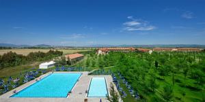 an overhead view of a large swimming pool with chairs at Borgo San Giorgio by La Principina in Grosseto