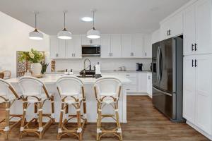 a kitchen with white cabinets and stainless steel appliances at Courtyard-Patio-Moutain and V3872-Holly House in Palm Desert