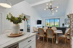 a kitchen and dining room with a table and chairs at Courtyard-Patio-Moutain and V3872-Holly House in Palm Desert