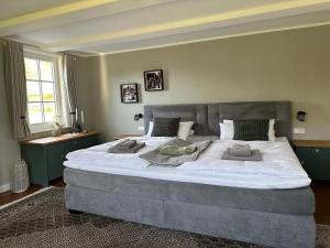 a large bed with two pillows on it in a bedroom at Ferienhaus Hallmanns Hof in Schmallenberg
