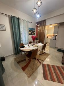 a dining room with a white table and chairs at Gemini Downtown Apartment in Zakynthos +3 photos