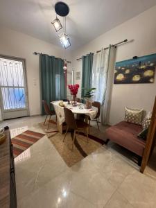 a living room with a table and a couch at Gemini Downtown Apartment in Zakynthos