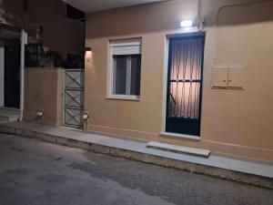 a building with a door and a window with a curtain at Gemini Downtown Apartment in Zakynthos