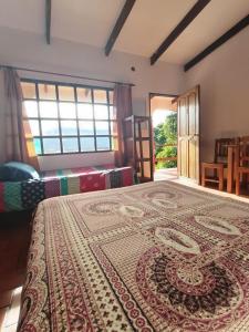 a bedroom with two beds and a large rug on the floor at El Cafetal in Coroico