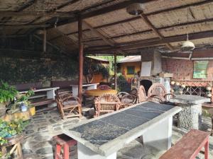 an outdoor patio with a table and chairs at El Cafetal in Coroico