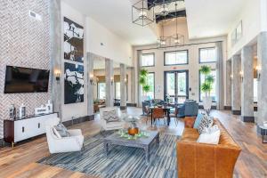 a living room with a couch and a table at Landing Apartments - Reserve at City Place in Conroe