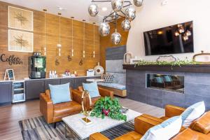 a living room with leather furniture and a fireplace at Landing Apartments - Reserve at City Place in Conroe