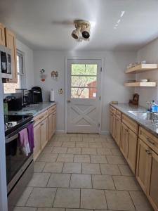 a kitchen with a door and a tile floor at Tory Hill in Hillsdale