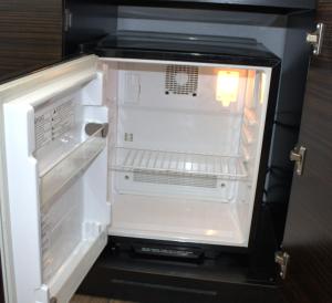 an empty refrigerator with its door open and its door is open at Torch Lite Lodge in Yuma