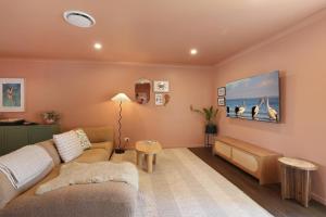 a living room with a couch and a table at Amity Duo - Roys in Amity Point