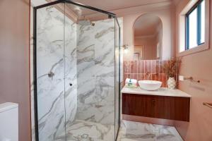 a bathroom with a shower and a sink at Amity Duo - Roys in Amity Point +10 photos