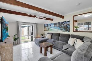a living room with a couch and a tv at Amity Oasis in Amity Point