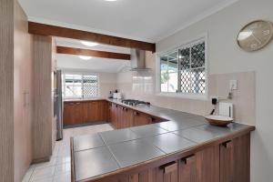 a large kitchen with wooden cabinets and a counter top at Amity Oasis in Amity Point
