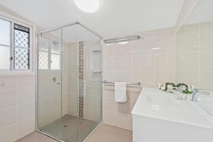 a bathroom with a glass shower and a sink at Amity Oasis in Amity Point +5 photos
