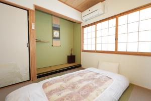 a bedroom with a bed and two windows at 嵐lan in Kyoto +17 photos