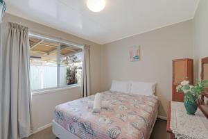 a bedroom with a bed and a window at Betty's Place in Amity Point