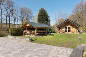 a log cabin with a picnic table in the grass at Vogtlandstadl - Vogtland Chalet in Bad Brambach