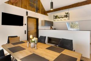 a dining room with a wooden table and chairs at Vogtlandstadl - Vogtland Chalet in Bad Brambach