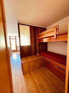 an empty room with two bunk beds in it at Stud 4 Pers Roche Béranger piscine in Chamrousse