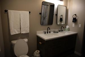 a bathroom with a sink and a toilet and a mirror at Retreat on First Street in Prescott +10 photos