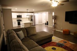 a living room with a couch and a kitchen at Retreat on First Street in Prescott