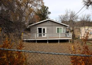 a house with a porch and a fence at Retreat on First Street in Prescott