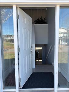 an open door of a house with a plant at Peaceful Stratford Home Bed and Breakfast - 2 BR Lower Level in Stratford