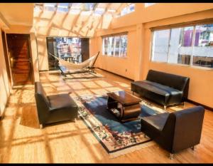 a living room with a couch and chairs and a hammock at Precioso Monoambiente Independiente in La Paz