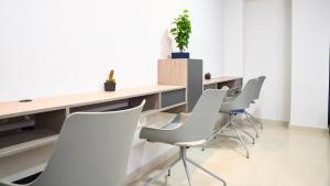 a meeting room with white chairs and a table at Hotel San Gabriel in Barrancabermeja