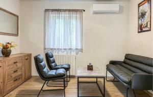 a living room with a couch and two chairs at Stunning Home In Krsan in Kršan