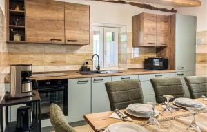 a kitchen with a table and some chairs and a counter at Stunning Home In Krsan in Kršan +19 photos
