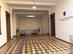 a room with a checkered floor and two chairs at Vista Catedral Guadalajara - Self Check in in Guadalajara