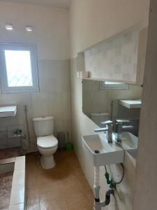 a bathroom with a toilet and a sink at Villa Cali SONOMA in Sambava +17 photos